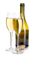 Two glasses of champagne on the background of brown bottles close-up isolated on a white. Festive still life.
