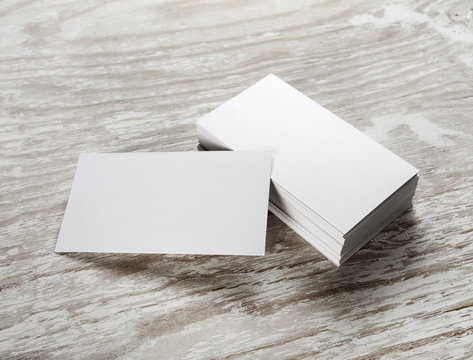 Blank business cards on wooden background. Mockup for branding identity for designers.