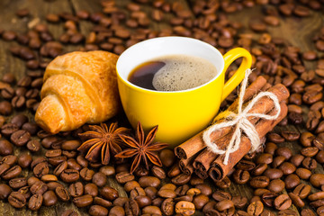 Coffee cup and saucer on a wooden table. Dark background, coffee