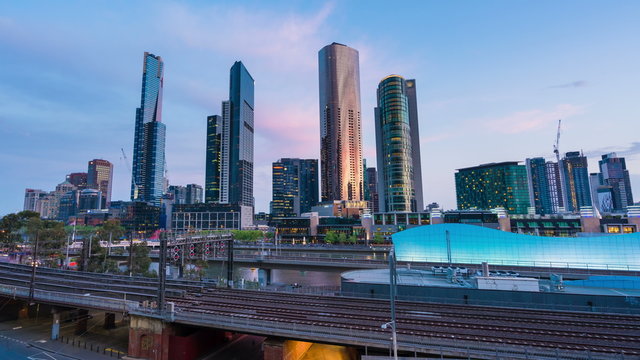 4k timelapse video of railway and office buildings in Melbourne CBD from sunset to night, camera zooming in