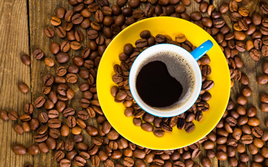 Coffee and coffee bean on wood background