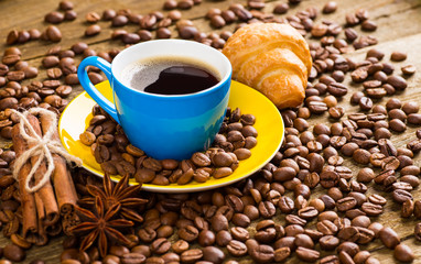 Coffee cup and saucer on a wooden table. Dark background, coffee