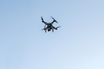 Drone with camera hovering in the sky