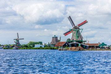 Naklejka premium Traditional Dutch old wooden windmill. Zaanse Schans, Zaandam.