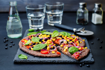 Black beans crust pizza with corn, spinach, tomatoes, black bean