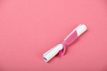 One white paper scroll message on pink background