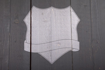 White shield on black wooden background