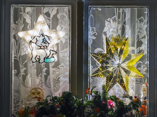 Christmas decorative lights of home window in night