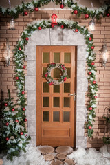 Fototapeta na wymiar The door to the house with Christmas wreath