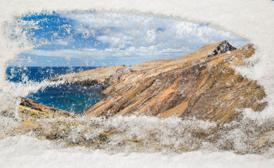 Through a site of the glass cleared of snow mountains and an oke