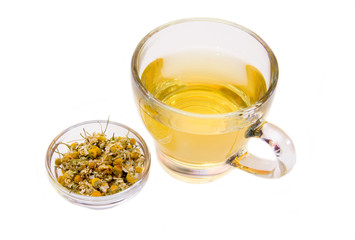 Cup of chamomile tea with flowers on white background