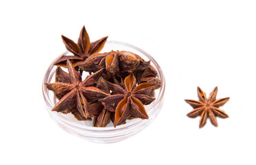 Star anise on bowl on white background