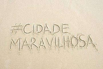 Hashtag social media message for the Cidade Maravilhosa (Marvellous City, the nickname of Rio de Janeiro, Brazil) written in smooth sand on the beach