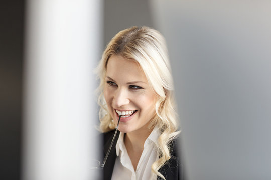 Smiling blond woman in office