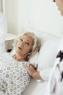 Senior woman in hospital looking worried