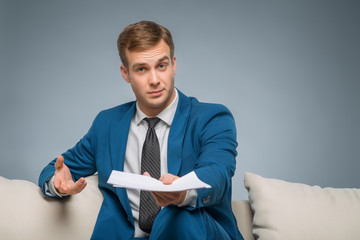 Handsome man upholding official papers. 