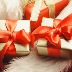 Small red and golden boxes with gifts tied bows