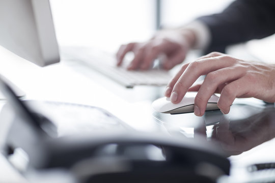 Close-up of man working on computer
