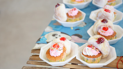 Donut and cup cake on table