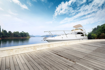 skyline wooden floor and yacht on lake