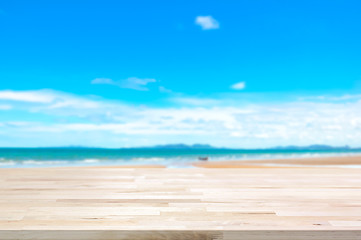 Fototapeta premium Wood table top on blur summer beach background