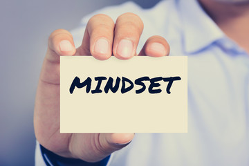 MINDSET, word on business card shown by a man