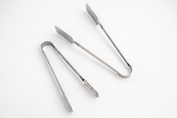 two ice tong on the white background