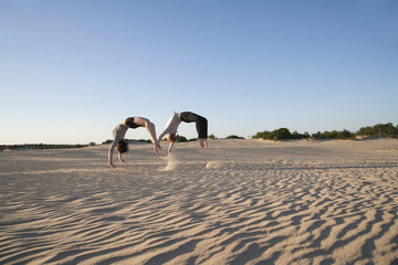 Netherlands, Acrobat couple performing synchronous backflips