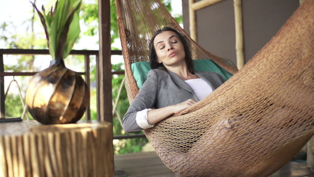 Businesswoman sleeping on hammock and waking up, super slow motion 240fps
