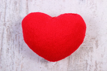 Valentine red heart on old wooden white table, symbol of love