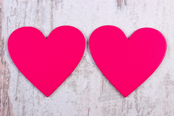 Valentine pink hearts on old wooden white table, symbol of love