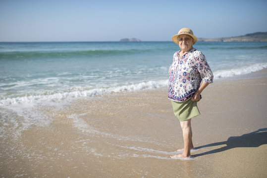 Spain, Ferrol, portrait of senior woman standing on the beach