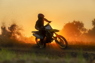 Obraz na płótnie Canvas Silhouette motocross speed in track