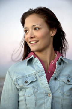 Smiling young woman in denim jacket