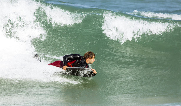 Spain, Asturias, Colunga, body board rider on the waves
