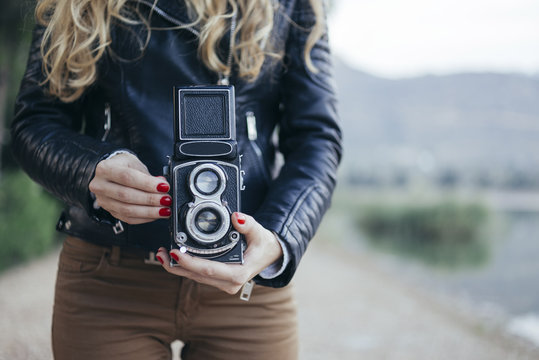 Woman using vintage camera