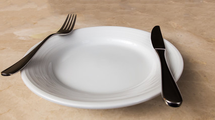Blank White Plate with Cutlery Fork and Knife on Marble Stone Table Background