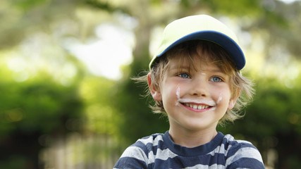 Portrait of smiling little boy with milk moustache
