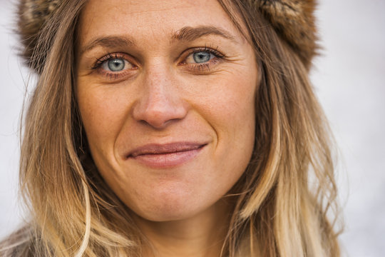 Portrait of smiling blond wearing fur cap