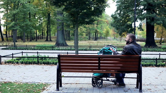 Angry man, parent talking on cellphone in the park
