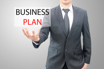 Business plan concept on hand of a businessman in suit