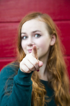 Teenage girl pointing on viewer