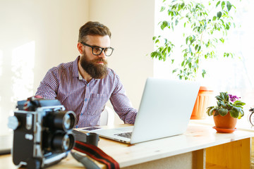 Beard young man working from home