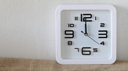 Alarm clock on wood table ( alarm clock show 12 o`clock )