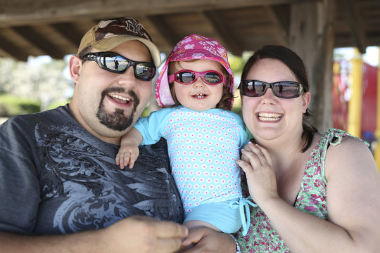 Father, mother and her little daughter wearing sunglasses