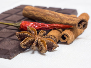 tender milk chocolate and cinnamon with anise on a wooden background
