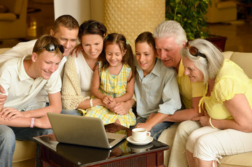 family sitting with laptop