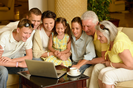 Family Sitting With Laptop