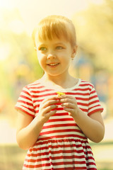 Little happy girl playing in park near the playground