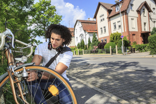 Young male student with racing cycle